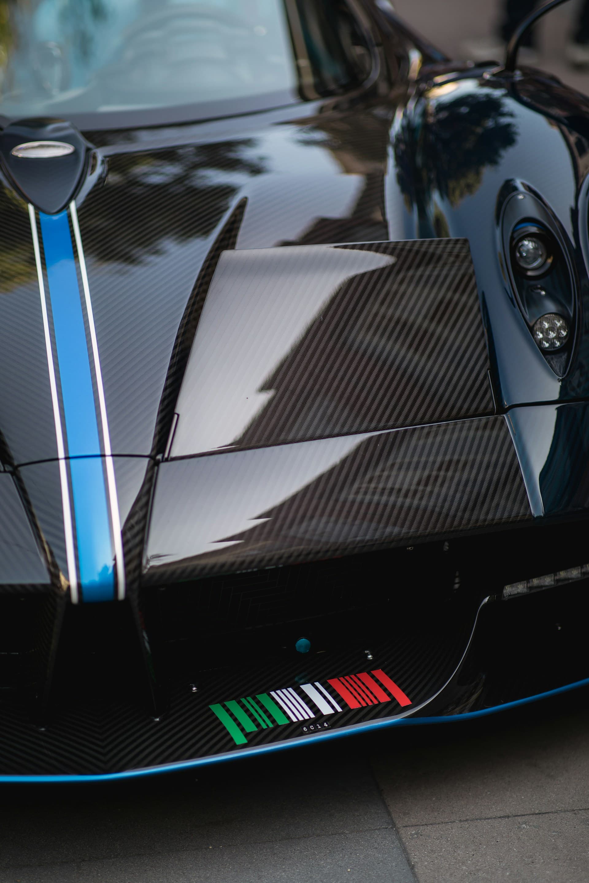 Carbon-fiber Pagani exotic reflecting its surroundings in a mirror finish